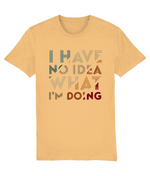 A short-sleeve womens crewneck t-shirt in a warm sandy beige color, featuring the text 'I HAVE NO IDEA WHAT I'M DOING' printed on the front in a retro, multi-colored distressed font.