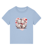 A womens light blue short-sleeve crewneck t-shirt featuring a cute graphic of two hugging white kittens inside a pink heart with small red hearts, displayed on a solid white background.