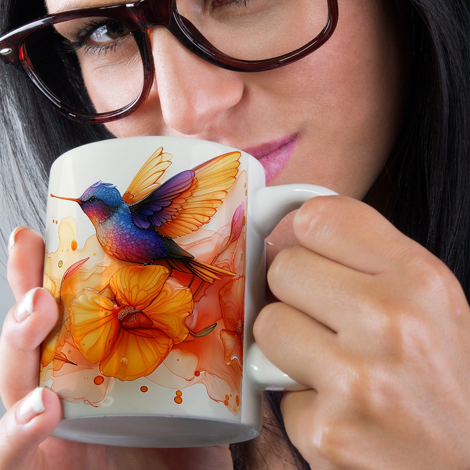 Woman holding a mug with a colorful hummingbird design