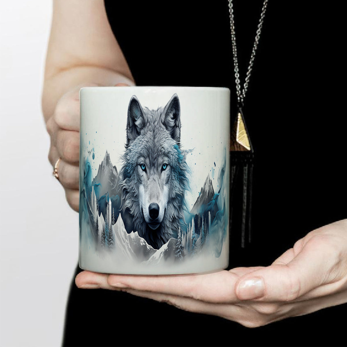 Woman holding a mug with a wolf design against a white background
