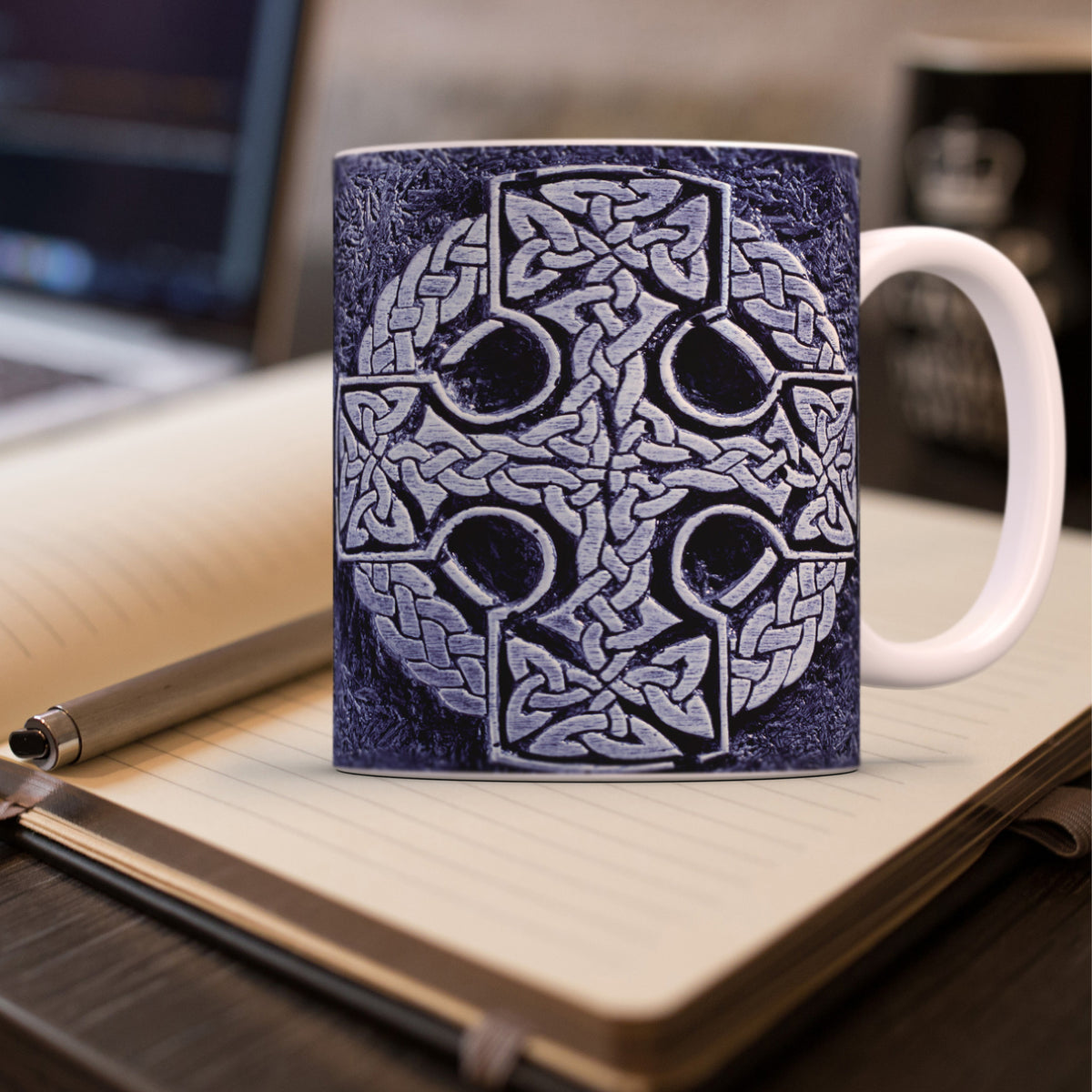 Mug with Celtic cross design on a notebook