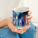 Woman holding a mug with huskies design against a white background