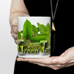 woman holding a white mug with green tea design and text