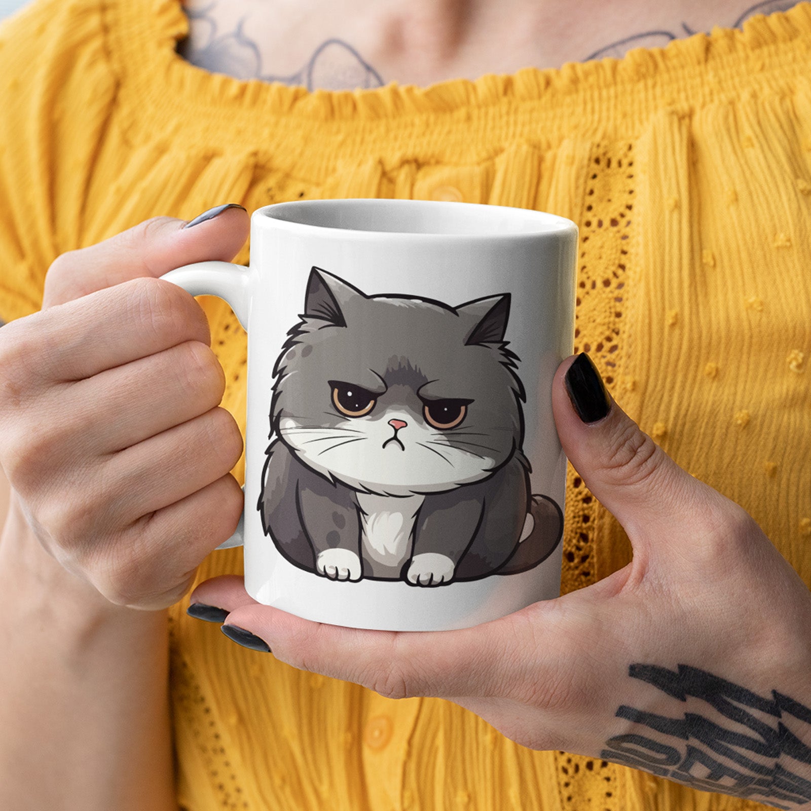Person holding a mug with a cat illustration against a yellow background