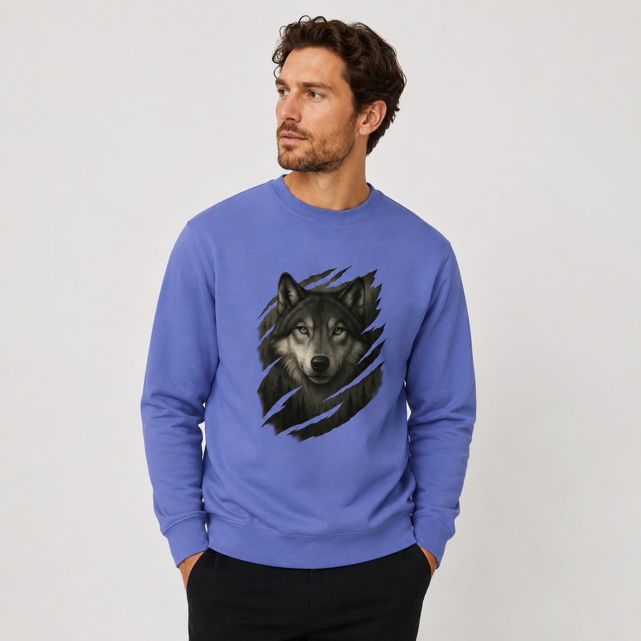 Man wearing a blue sweatshirt with a wolf graphic on a plain background