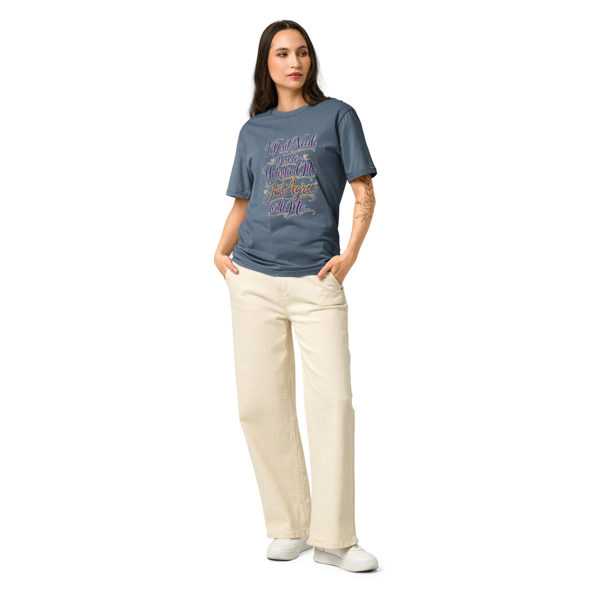 Woman wearing a Stanley/Stella  green shirt with yellow buttons and beige pants on a white background