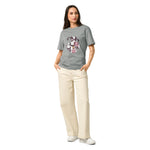 Woman wearing Stanley/Stella  gray t-shirt with colorful graphics and text, standing against a white background