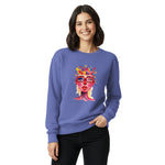 Woman wearing a blue sweatshirt with a colorful graphic design on a white background