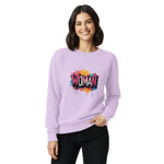 Woman wearing a Comfort Colors light purple sweatshirt with colorful 'WOMAN' graphic on a white background