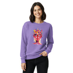 Woman wearing a purple sweatshirt with a colorful graphic design on a white background