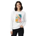 Woman wearing a white sweatshirt with a colorful floral design on a white background