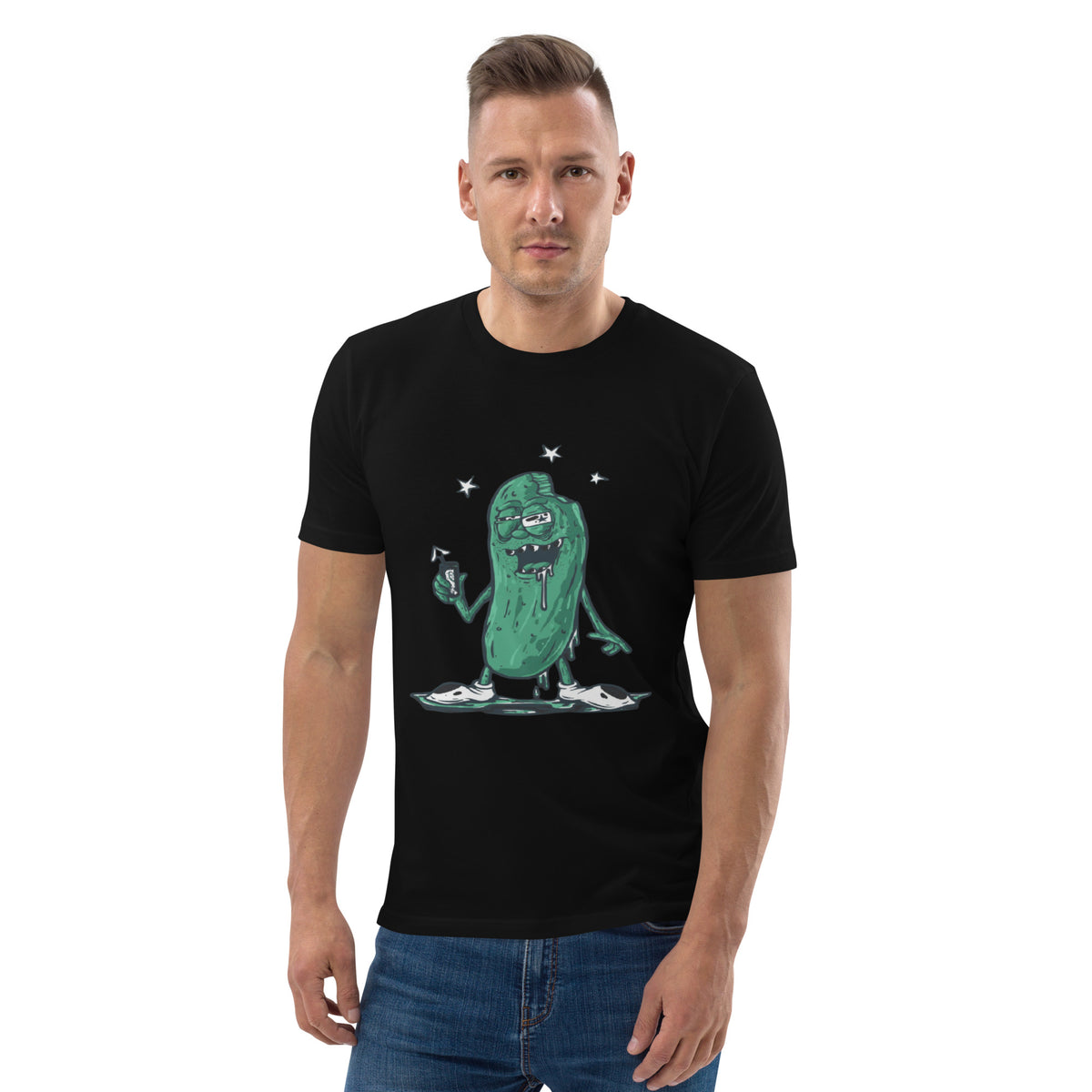 Man wearing a black t-shirt with a green pickle monster graphic on a white background