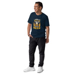 Man wearing a navy blue t-shirt with a graphic design and text, standing against a white background