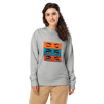 Woman wearing a gray sweatshirt with eye graphic design on a white background