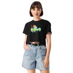 Woman wearing a black crop t-shirt with colorful text and denim shorts on a white background