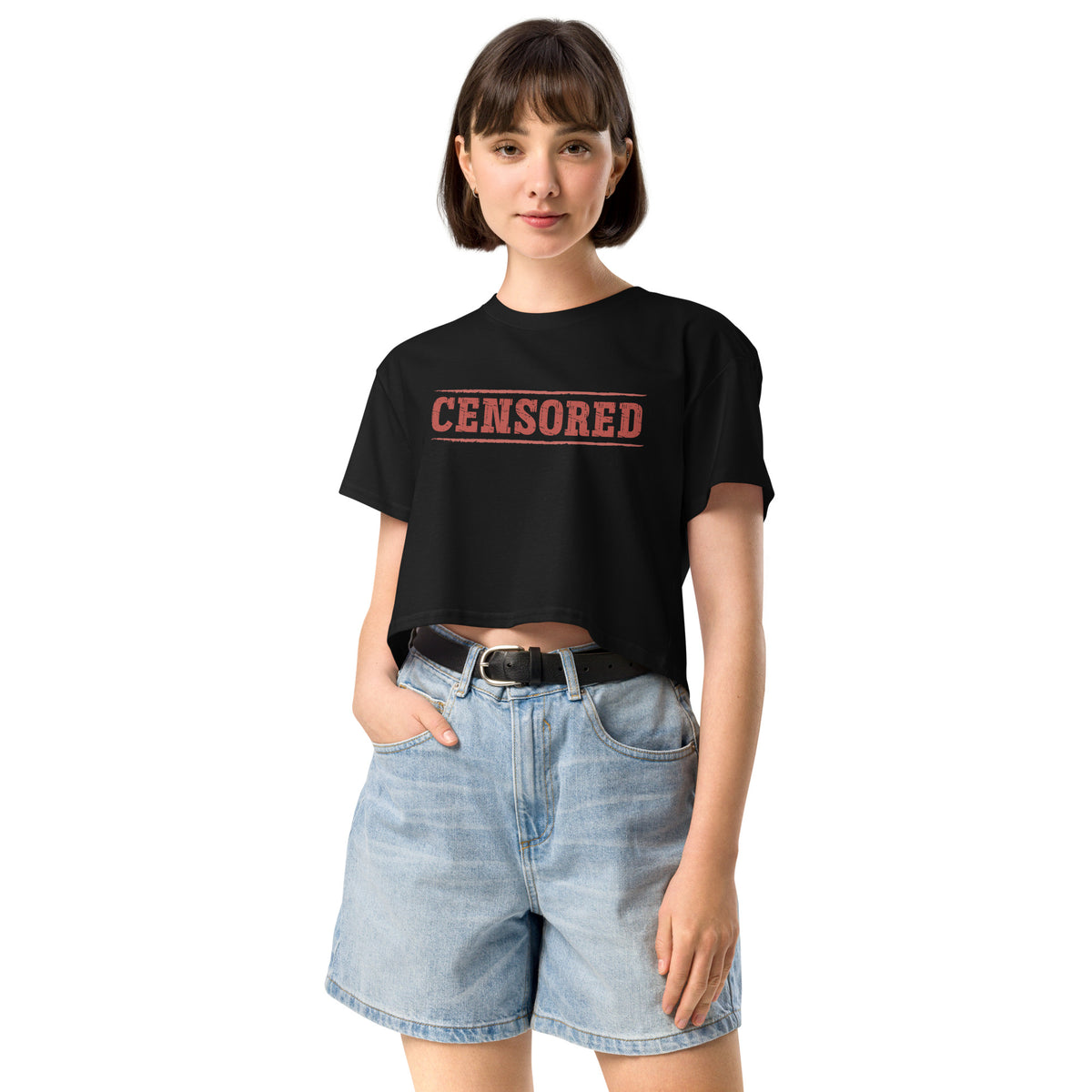 Woman wearing a black t-shirt with 'CENSORED' text and denim shorts on a white background