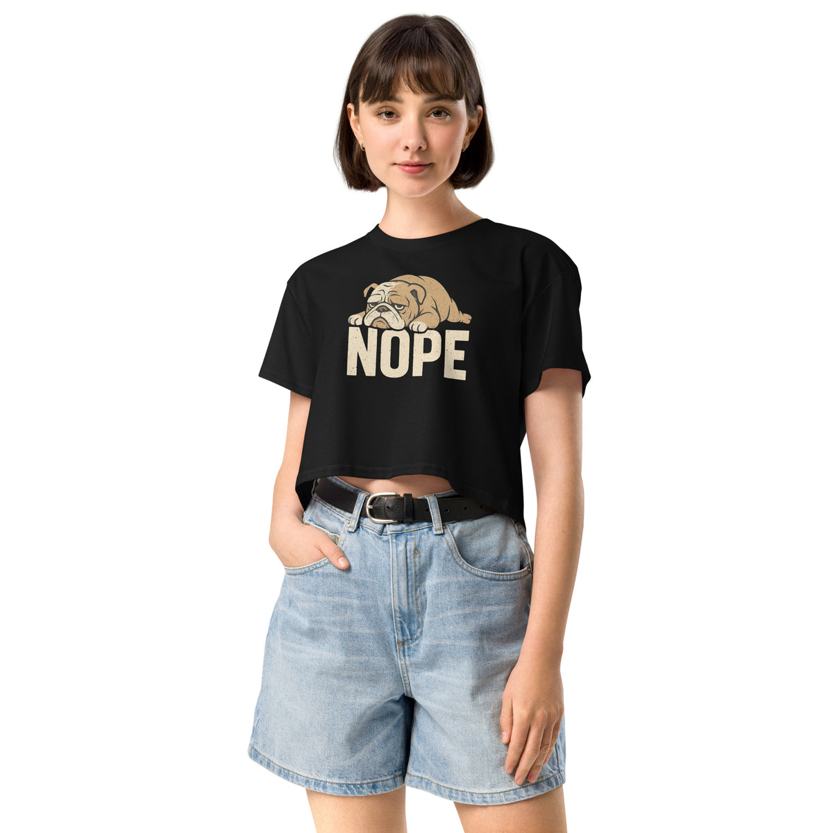 Woman wearing a black t-shirt with a bulldog graphic and 'NOPE' text, paired with denim shorts on a white background.