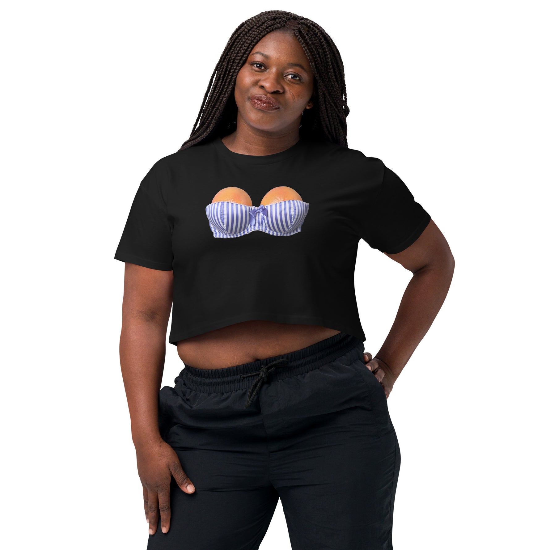 Woman wearing a black crop top with a graphic design on a white background