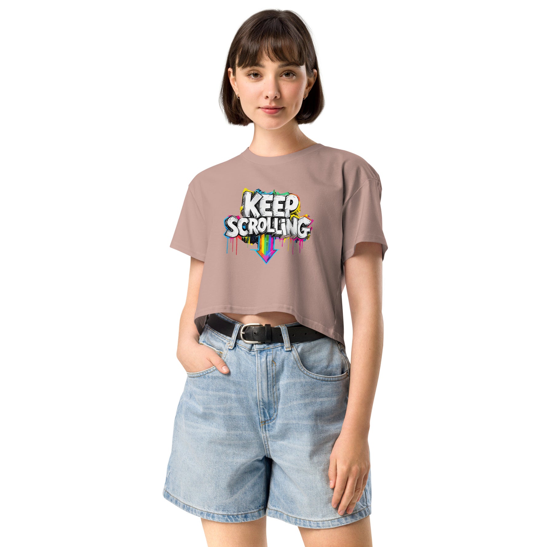 Woman wearing a beige t-shirt with 'Keep Scrolling' text and denim shorts on a white background