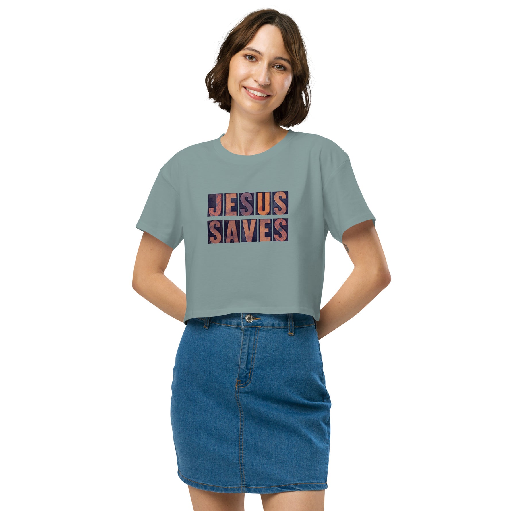 Woman wearing a light blue crop t-shirt with 'JESUS SAVES' text on a white background