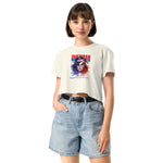 Woman wearing a white crop t-shirt with a graphic design and denim shorts on a white background