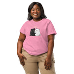 Woman wearing a pink t-shirt with cartoon cats on a white background