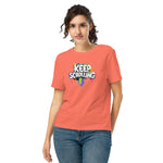 Woman wearing a coral t-shirt with 'Keep Scrolling' graphic design on a white background