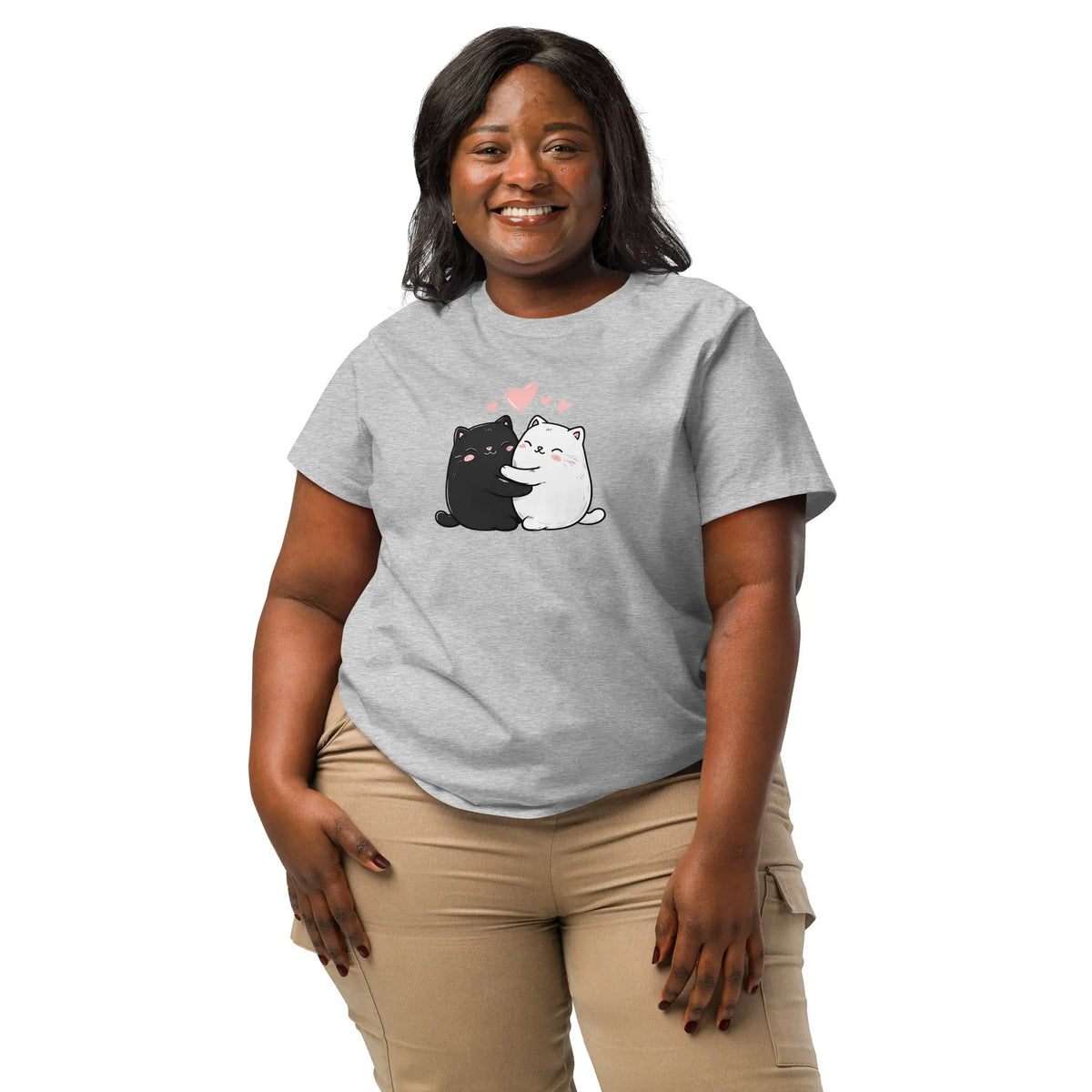 Woman wearing a gray t-shirt with cartoon cat design on a white background