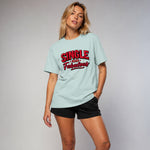 Woman wearing a light blue t-shirt with 'Single and Fabulous' text on a plain background