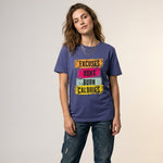 Woman wearing a purple t-shirt with motivational text on a plain background