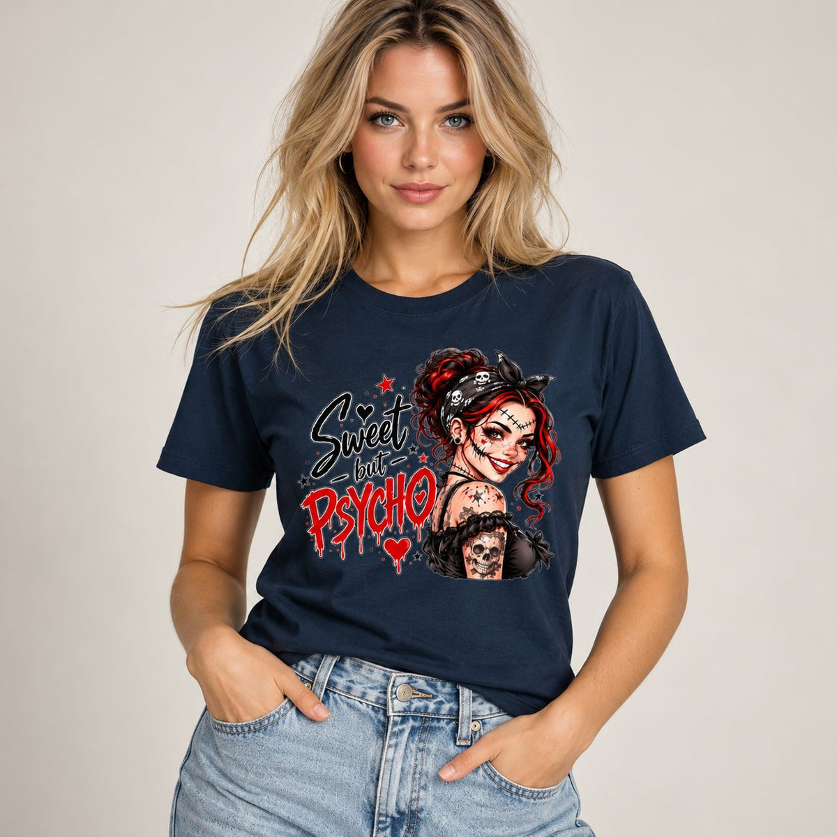 A woman wearing a navy blue graphic t-shirt with a 'Sweet but Psycho' Harley Quinn design, paired with light wash blue jeans, against a neutral beige background.