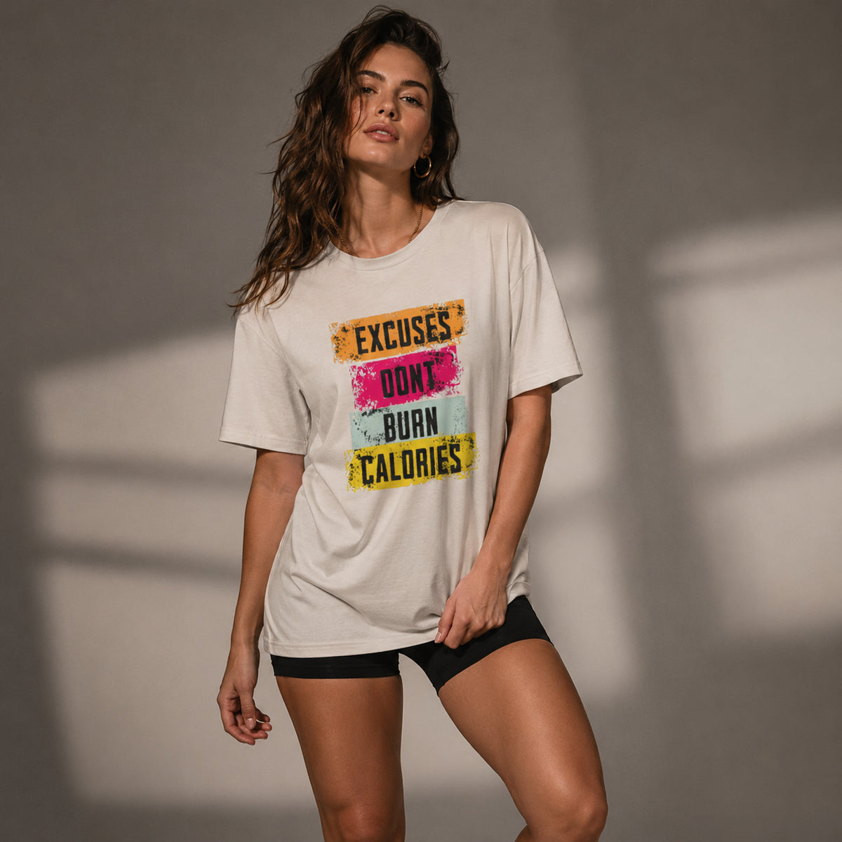 Woman wearing a t-shirt with motivational text against a neutral background