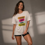 Woman wearing a t-shirt with motivational text against a neutral background