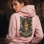 Woman wearing a pink hoodie with a religious design on the back