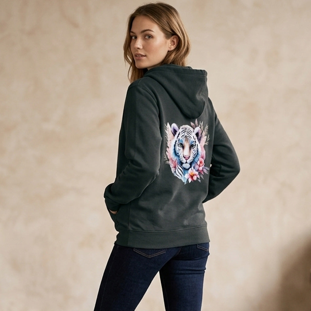 Woman wearing a dark green hoodie with a colorful tiger design on the back against a beige background