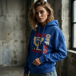 Woman wearing a blue hoodie with graphic design in an industrial setting