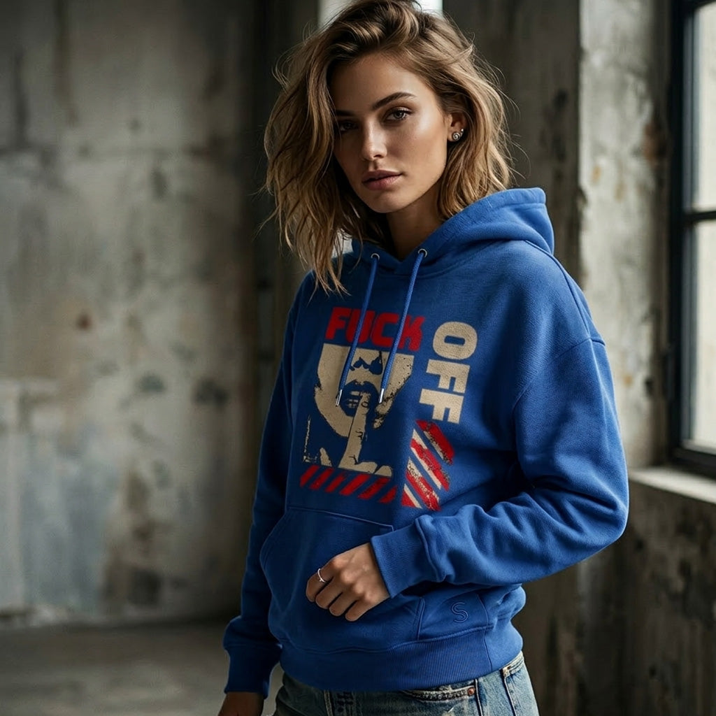 Woman wearing a blue hoodie with graphic design in an industrial setting