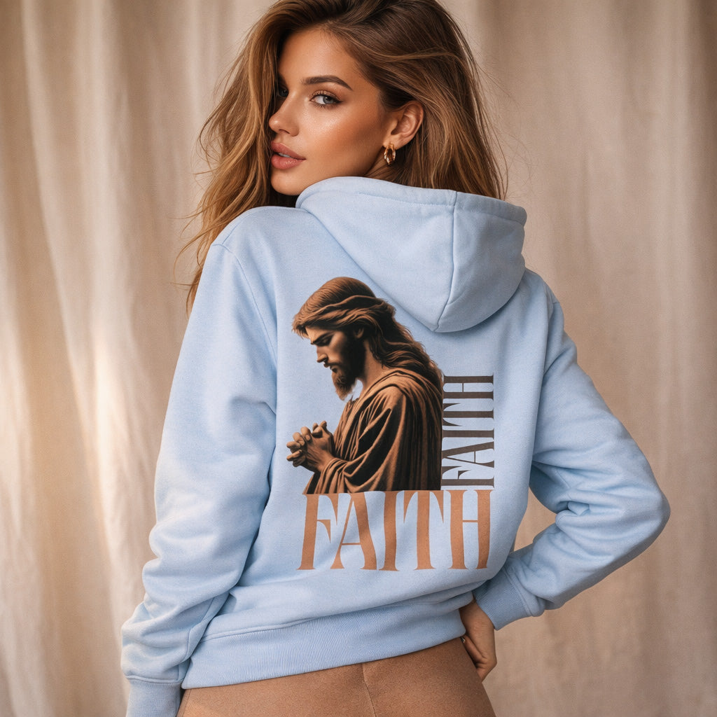 Woman wearing a light blue hoodie with a graphic of a religious figure and the word 'FAITH' on the back.
