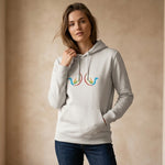 Woman wearing a light gray hoodie with a colorful design on a beige background