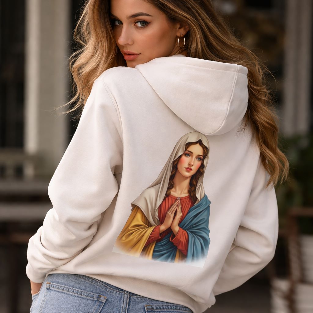 Woman wearing a white hoodie with an embroidered design of a religious figure.