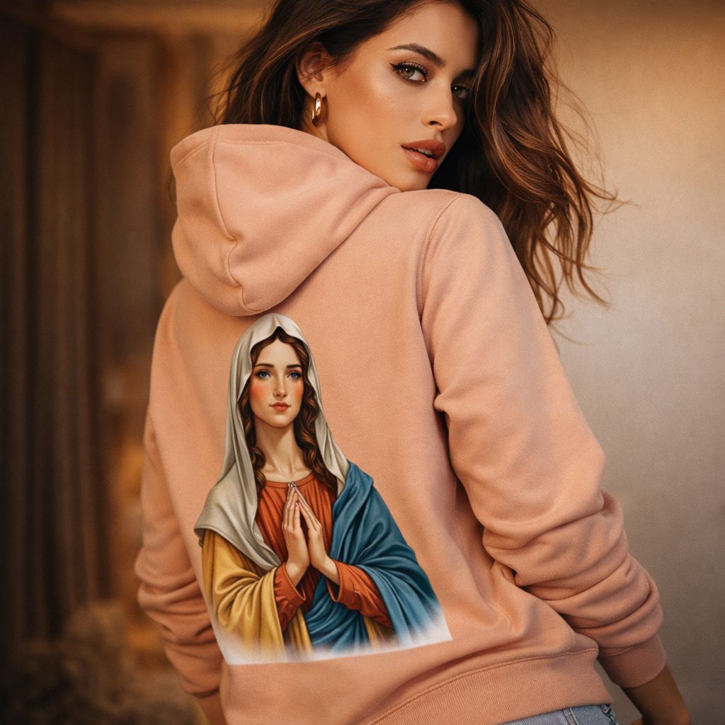Woman wearing a peach hoodie with an image of a religious figure on the back