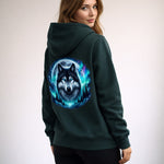 Woman wearing a dark green hoodie with a wolf graphic on the back against a plain background
