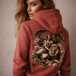 Woman wearing a red hoodie with a detailed design on the back against a neutral background