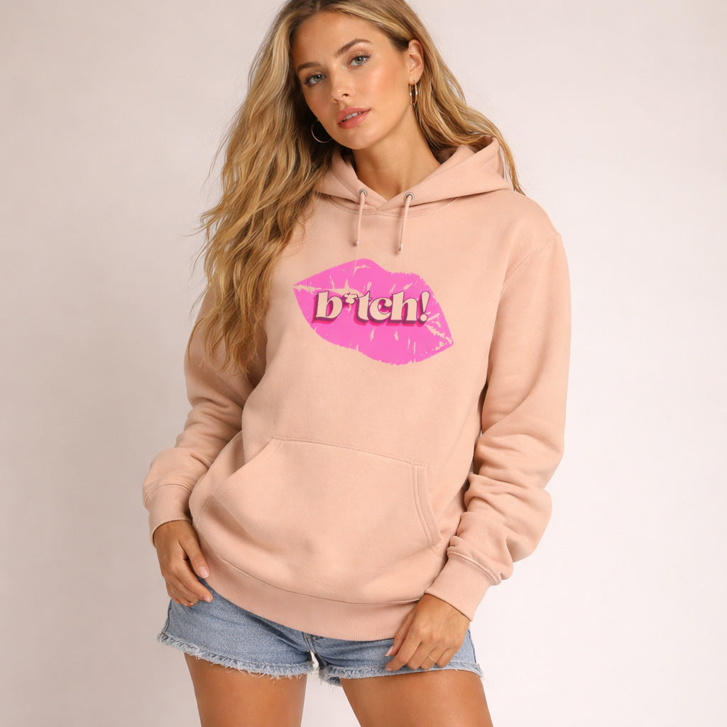 Woman wearing a pink hoodie with a graphic design on a plain background
