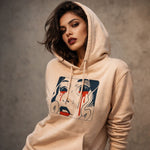 Woman wearing a beige Stanley/Stella hoodie with a graphic design on a neutral background
