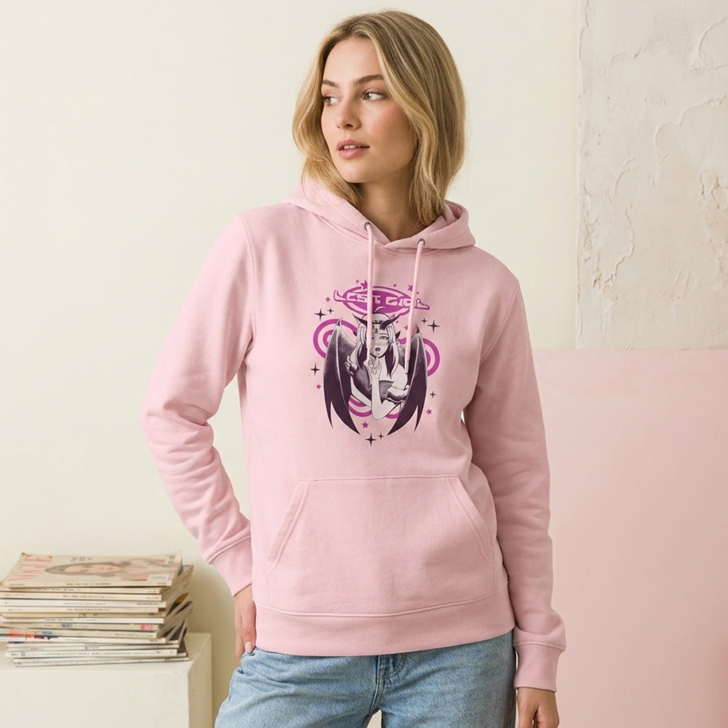 Woman wearing a pink hoodie with a graphic design, standing against a light-colored wall.