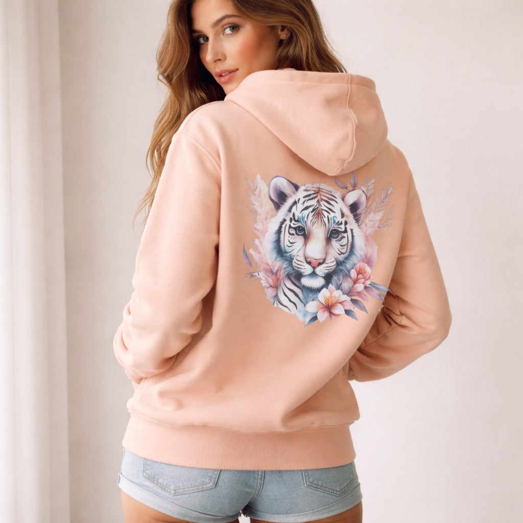 Woman wearing a peach hoodie with a tiger design on the back against a plain background