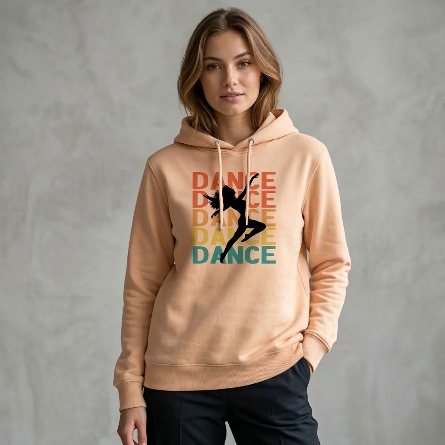 Woman wearing a beige hoodie with a dancer graphic and 'DANCE' text on a gray background