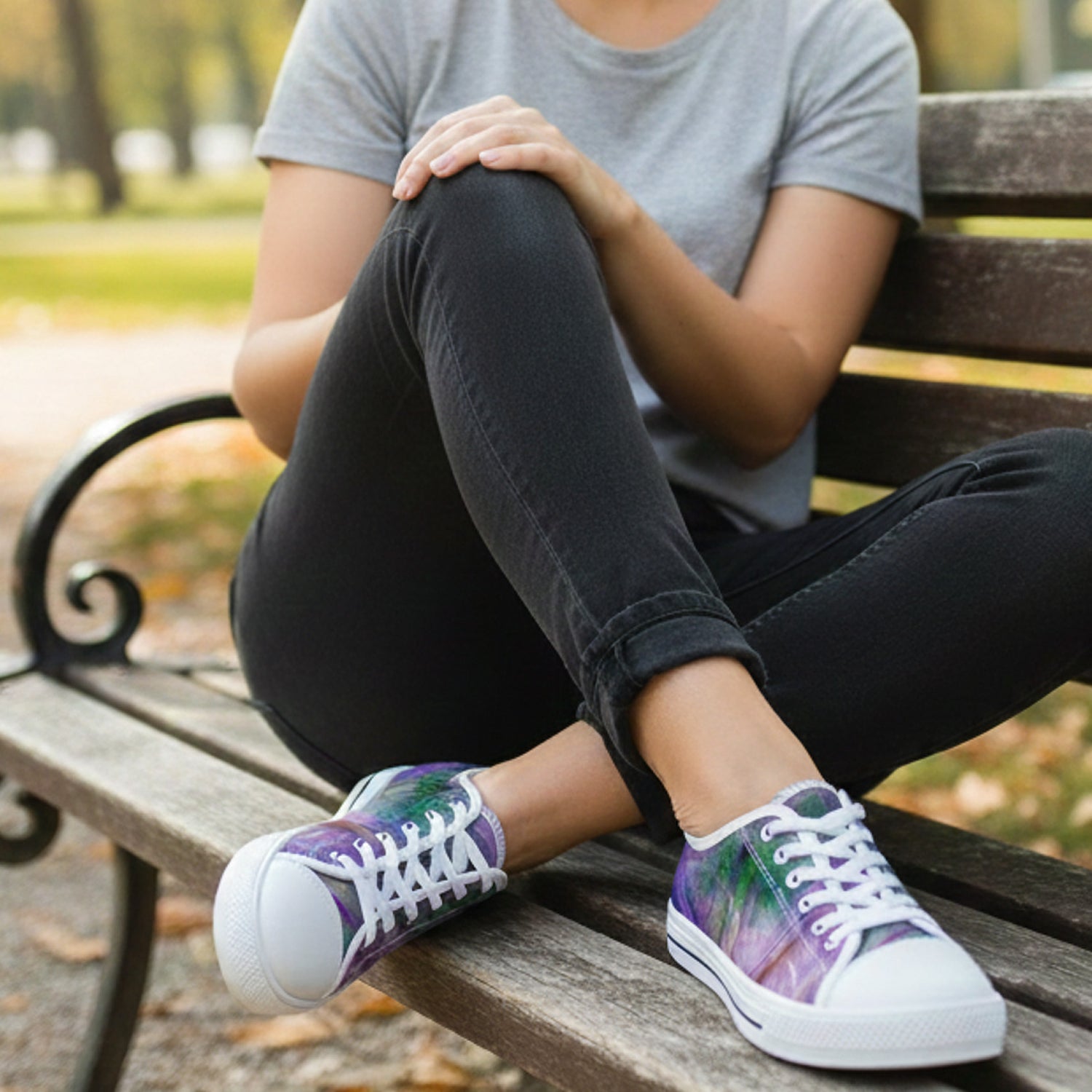Woman sitting on a bench wearing purple sneakers with palm tree design