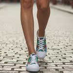 Colorful sneakers on a person walking on a cobblestone street